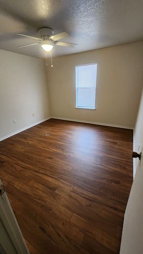 Copperas Cove apartment for rent - A room with a ceiling fan and wooden flooring.