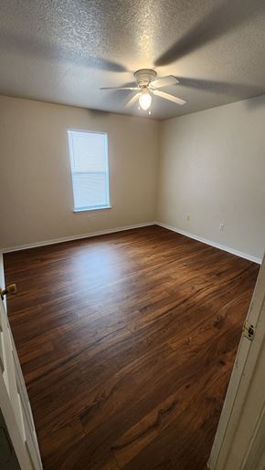 Copperas Cove apartment for rent - A room with a ceiling fan and wooden flooring.