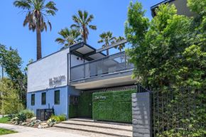 Los Angeles apartment for rent - A modern house with a blue exterior and a green wall on the front.