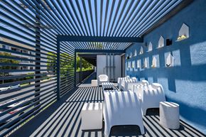 Los Angeles apartment for rent - A patio with white chairs and a striped floor.
