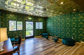Los Angeles apartment for rent - A room with green patterned walls and a wooden floor.