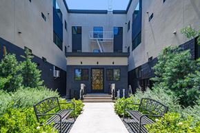 Los Angeles apartment for rent - A modern building with a glass door and a balcony.