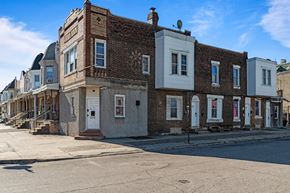 Philadelphia apartment for rent - A row of old brick buildings with white trim and doors.