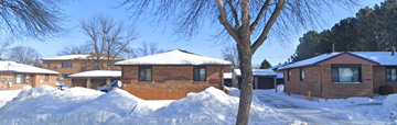 Moorhead apartment for rent - A house with a brown roof and a tree in front of it.