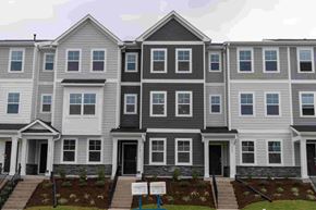 Apex house for rent - A row of townhouses with grey and white exteriors.
