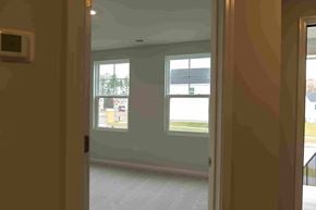 Apex house for rent - A glass door with a window and a view of a parking lot.