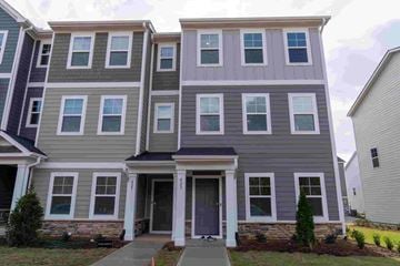 Apex house for rent - A grey and white two story house with a grey front door.