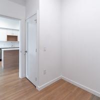 Victoria apartment for rent - A white door is open to a kitchen.