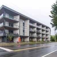 Victoria apartment for rent - A large apartment building with balconies and a fire hydrant in front.