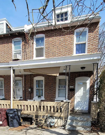 Wilmington house for rent - A two-story brick house with a white door and windows.