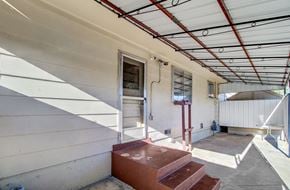Colorado Springs house for rent - A white building with a red staircase.