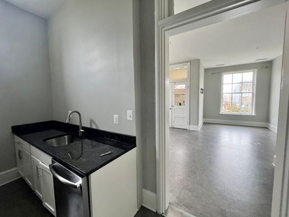 Baltimore apartment for rent - A kitchen with a black counter top and white cabinets.