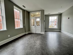 Baltimore apartment for rent - A room with a grey floor and a white door.