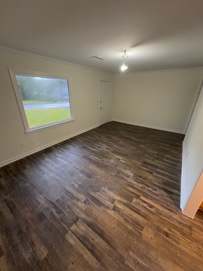 Smyrna house for rent - A room with wooden flooring and a window overlooking a grassy area.