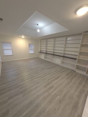 Smyrna house for rent - A room with wooden flooring and shelving units.