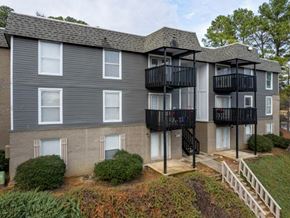 Hoover apartment for rent - A grey apartment building with black railings and white windows.