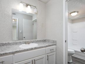 Hoover apartment for rent - A bathroom with a sink, mirror, and toilet.