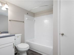 Hoover apartment for rent - A white toilet sits next to a white bathtub in a small bathroom.
