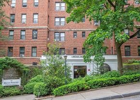 White Plains apartment for rent - A red brick building with a white entrance and a sign that says Broad Street.