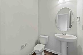 Apex house for rent - A white toilet and sink in a bathroom.