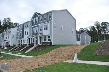 Apex house for rent - A row of houses with a white and grey exterior.