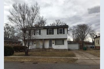 Gary house for rent - A two-story house with a white siding and a grey roof.
