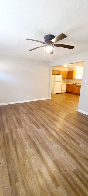 Clarksville house for rent - A room with a ceiling fan and wooden flooring.