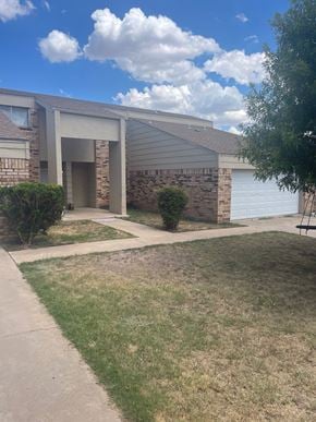 San Angelo house for rent - A house with a white garage door and a driveway.