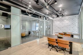 Oakland apartment for rent - A conference room with glass walls and orange chairs.