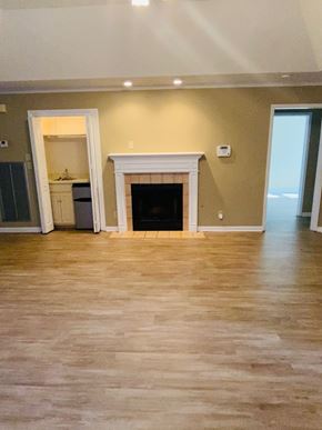 Montgomery house for rent - A living room with a fireplace and hardwood floors.
