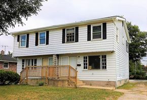 Gary house for rent - A white house with a brown porch.