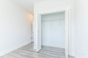 Chicago apartment for rent - A white doorway opens to a room with a grey floor.