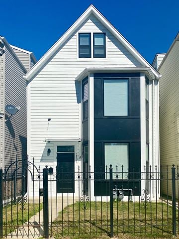 Chicago apartment for rent - A white house with a black door and a black fence.