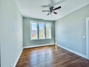 Chicago apartment for rent - A room with a ceiling fan and a window.