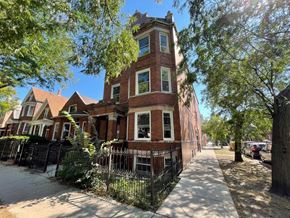 Chicago apartment for rent - A row of houses with a tree in front of them.