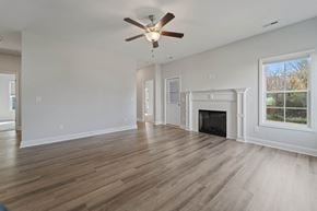 Richlands house for rent - A spacious living room with a fireplace and a ceiling fan.