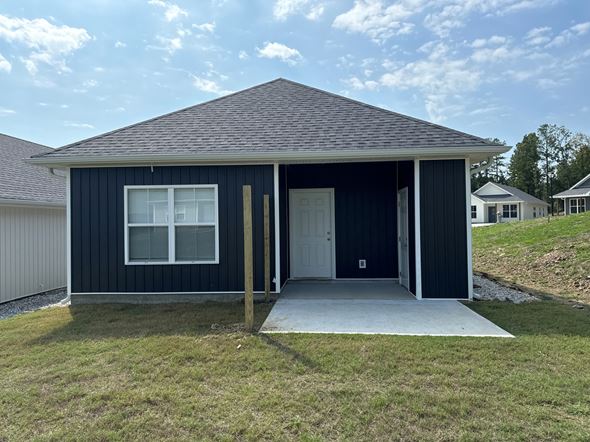 Little Rock house for rent - A small house with a dark blue exterior and a white door.