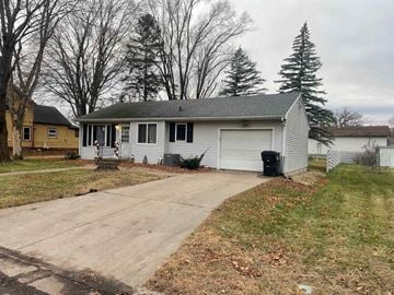 Menomonie house for rent - A house with a grey roof and a white garage door.