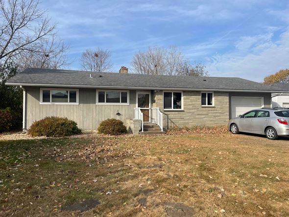Menomonie house for rent - A house with a car parked in front.