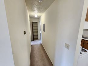 Lansing apartment for rent - A long hallway with a door at the end.