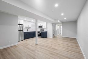 Calgary apartment for rent - A spacious kitchen with a refrigerator, microwave, and oven.