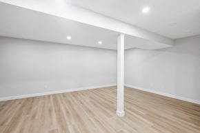 Calgary apartment for rent - A room with a white column and wooden flooring.