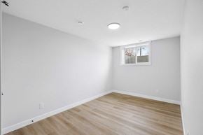 Calgary apartment for rent - A room with wooden flooring and a window with blinds.