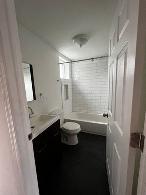 Philadelphia apartment for rent - A white bathroom with a toilet, sink, and bathtub.