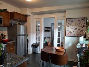 Philadelphia apartment for rent - A kitchen with a refrigerator, a table and chairs, and a painting on the wall.