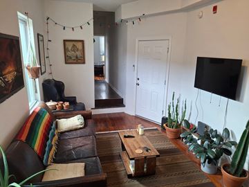 Philadelphia apartment for rent - A living room with a brown couch and a wooden coffee table.