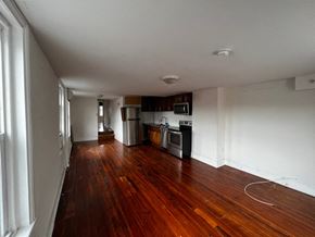 Philadelphia apartment for rent - A kitchen with wooden floors and white walls.