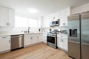 Los Angeles apartment for rent - A kitchen with white cabinets and stainless steel appliances.