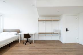 Los Angeles apartment for rent - A white bedroom with a bed, desk, and chair.