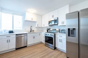 Los Angeles apartment for rent - A kitchen with white cabinets and stainless steel appliances.